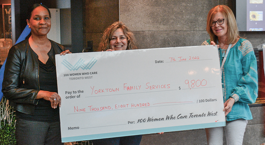 Gabbey Dessye and Fatima Valetim accepting $9,800 donation cheque from 100 Women Who Care Toronto West