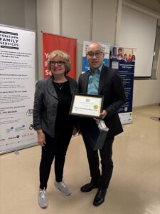 Shoppers Drug Mart Rep receiving Community Partnership award from Yorktown Family Services