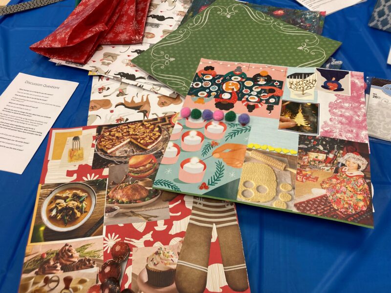 colourful scrapbooking materials spread out on a table with a blue tablecloth