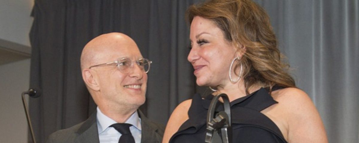 couple standing at podium accepting an award