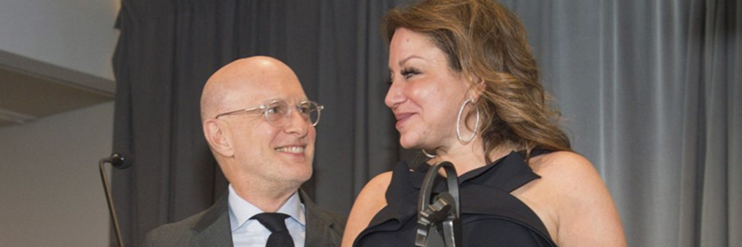 couple standing at podium accepting an award