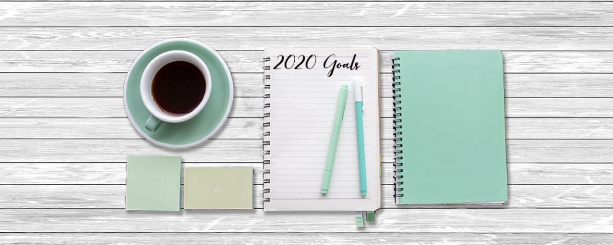 notepad and coffee on table