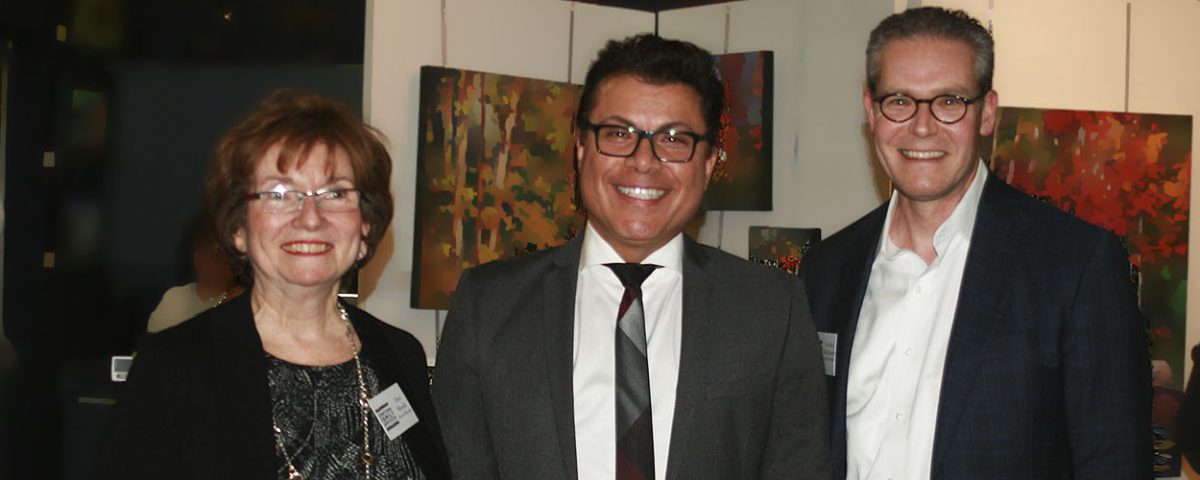 three people posing for camera