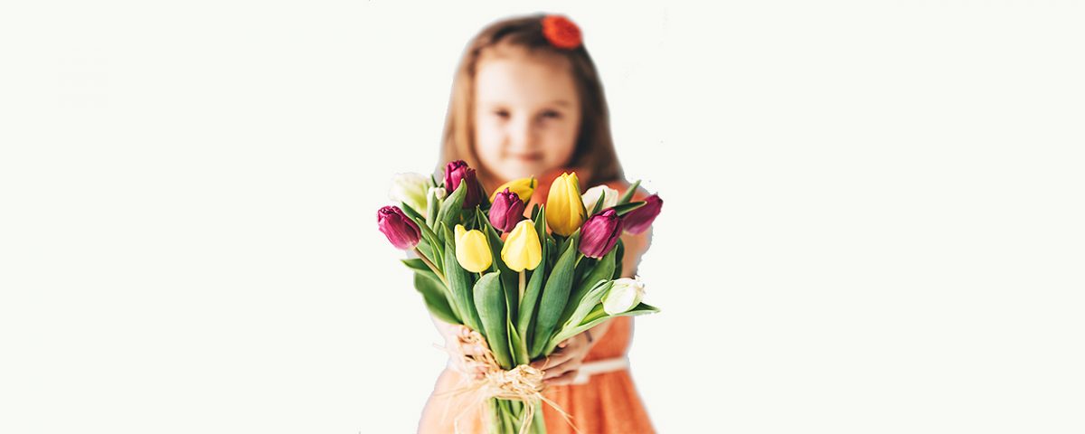 young girl offering bouquet of flowers