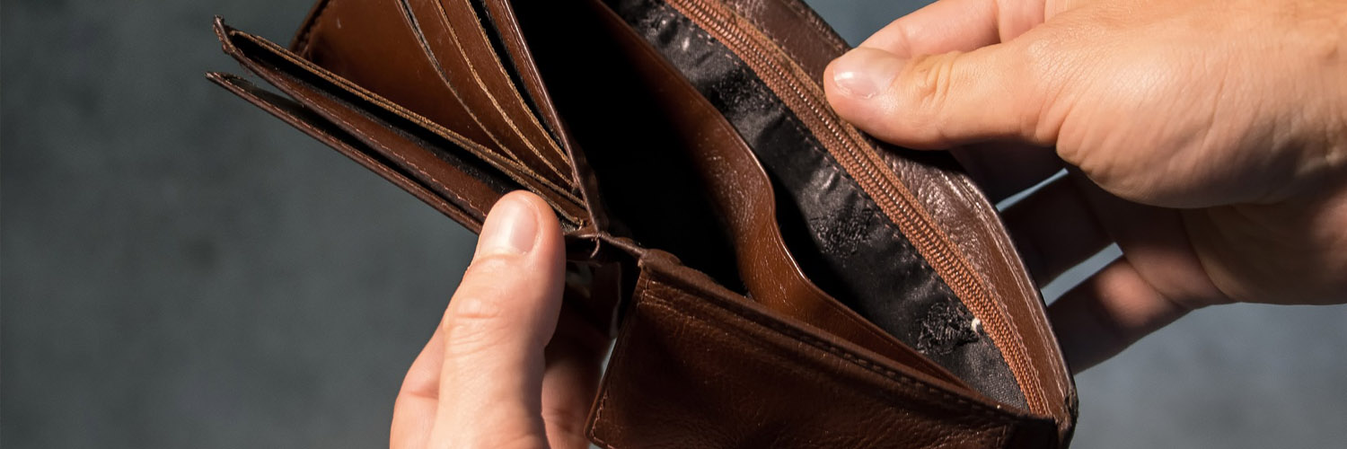 person's hands opening empty wallet
