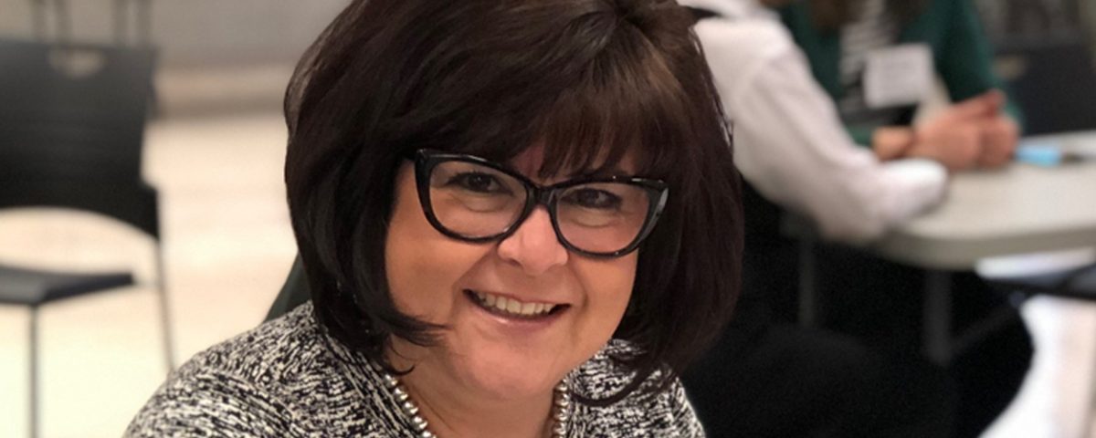 woman sitting at table in meeting room